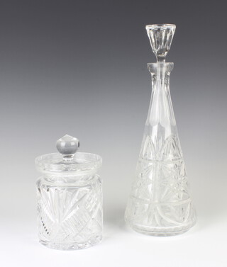 A cut glass biscuit barrel and cover and a tapered decanter and stopper