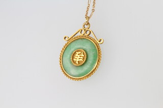 A yellow gold mounted jade pendant and chain 
