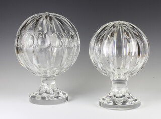 Two faceted glass round spheres on round bases 32cm and 29cm 