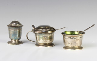 An Edwardian silver 3 piece condiment set with green glass liners, Birmingham 1911