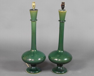 A pair of stylish green glazed Studio Pottery vases with elongated necks converted to electricity 60cm 