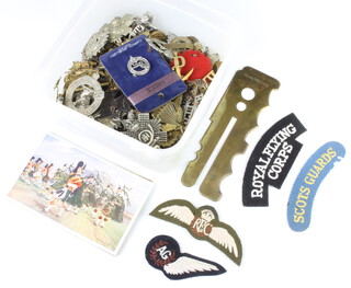 A quantity of Second World War and later army cap badges etc