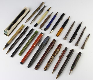 A Watermans red marbled fountain pen, a silver propelling pencil and minor pens and pencils