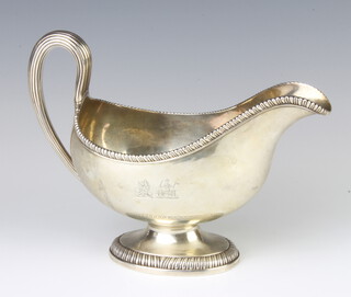 A George III silver sauce boat with egg and dart rim and simple scroll handle, London 1773, maker John Parker and Edward Wakelin, bearing a double armorial,  600 grams, 23cm 
