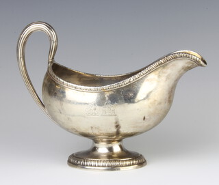 A George III silver sauce boat with egg and dart rim and simple S scroll handle with double armorial, London 1773, maker John Parker and Edward Wakeling, 397 grams