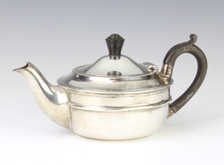 A silver breakfast teapot with ebony  mounts London 1918, gross 310 grams