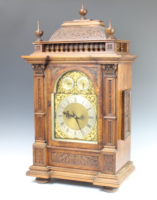 Winterhalder and Hofmeier, a Victorian double fusee striking bracket clock, the 22cm arched dial with strike/chime indicator, slow/fast indicator and gilt metal spandrels, silvered chapter ring and numerals, striking on 2 gongs, the 13cm back plate marked D.R. Patent W and H SCH, contained in a carved walnut case  