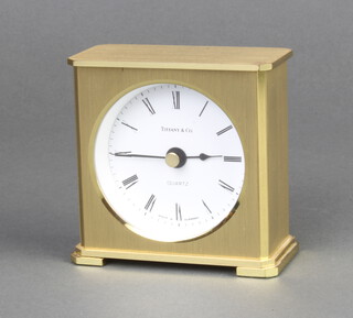 A quartz timepiece with paper dial and Roman numerals, the dial marked Tiffany and Co, Made in Germany, contained in a gilt case 8cm x 7.5cm x 4cm 