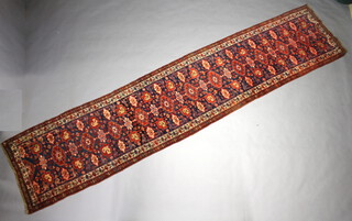 A blue, red and white ground Persian Bidjar runner with 13 stylised octagons to the centre within a multi row border 473cm x 103cm 