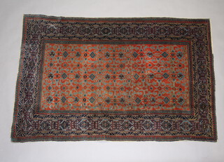 A blue and tan ground Caucasian rug, having a central medallion and geometric design within multi row borders 151cm x 100cm 