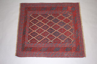 A red and blue ground Gazak rug with diamond medallions to the centre within a multi row border  125cm x 120cm 