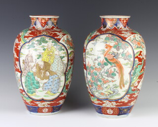 A pair of Imari vases decorated with panels of figures, birds and flowers 32cm 