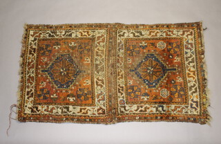 A brown, green and blue ground Caucasian style rug with 2 medallions to the centre 149cm x 82cm 