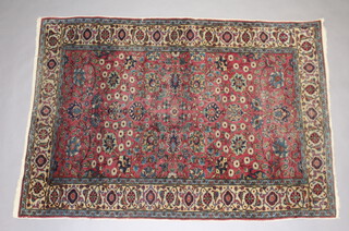 A pink, blue and white ground Kaysari rug with floral pattern within a 3 row border 171cm x 122cm 