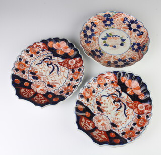 A pair of shell shaped Imari scalloped dishes decorated with exotic birds 23cm, a ditto plate decorated flowers 20cm 