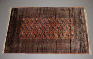 A brown ground Bokhara carpet with 36 octagons to the centre within a multi row border 257cm x 160cm 