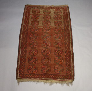 A red ground Afghan rug with 27 octagons to the centre 232cm x 135cm 