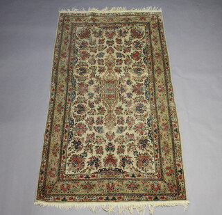 A white ground and floral patterned Persian carpet with central medallion within a multi row border, 244cm x 134cm 
