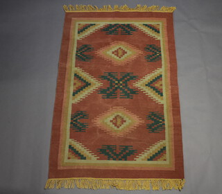 A pink and blue ground Kilim with geometric designs to the centre 177cm x 114cm 