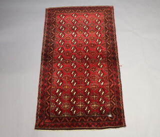 An Afghan red and white ground rug with 56 stylised medallions to the centre within a multi row border 227cm x 210cm x 114cm 