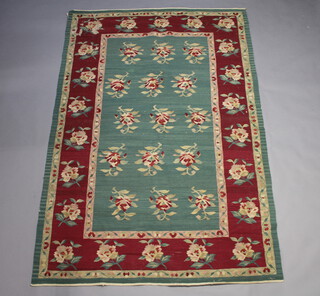 A green and red ground floral patterned kilim rug 262cm x 175cm 