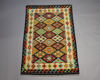 A yellow, turquoise and tan ground Chobi rug with all over geometric design 186cm x 124cm