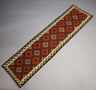 A red, blue and tan ground Maimana Kilim runner with all over geometric design 300cm x 79cm 