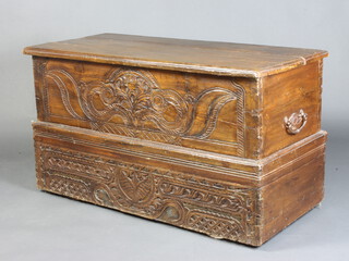 A 18th Century Continental carved hardwood coffer with hinged lid and iron drop handles to the sides, the interior fitted a candle box 64cm h x 114cm w x 52cm d 