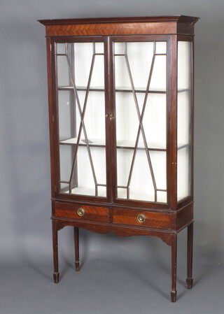 An Edwardian mahogany display cabinet, the upper section with moulded cornice, fitted shelves enclosed by astragal glazed panelled doors, raised on square tapered supports, spade   feet 170cm h x 94m w x 34cm d 