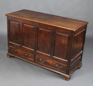 An 18th Century oak mule chest of panelled construction with hinged lid, the base fitted 2 long drawers, raised on bracket feet 83cm h x 131cm w x 62cm d 