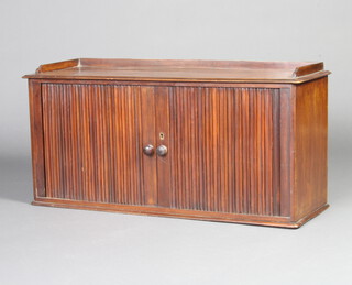 A 19th Century mahogany table top cabinet with three-quarter gallery, the interior fitted 18 pigeon holes enclosed by a tambour shutter 44cm h x 91cm w x 29cm d 