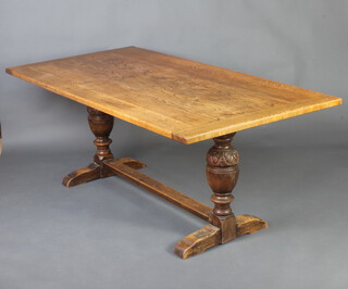 An elm 17th Century style refectory dining table with plank top, raised on cup and cover supports with H framed stretcher 75cm h x 188cm w x 95cm d 