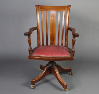 An Edwardian inlaid mahogany stick and bar back revolving office chair