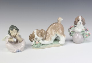 A Lladro figure of a puppy with vase of flowers 5574 10cm, ditto of a seated angel with a hand bell, ditto puppy beside a flower 10cm   
