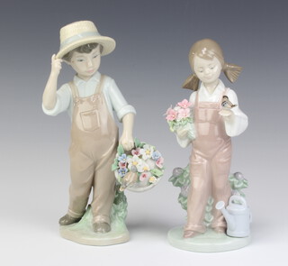 A Lladro figure of a boy holding a basket of flowers, a ditto of a girl holding a bouquet of flowers, both 19cm 