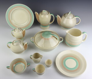 A Susie Cooper tea, coffee and dinner service comprising large teapot, small teapot, hot water jug, coffee pot, large jug, medium jug, small jug, 6 coffee cups, 5 saucers, 5 tea cups, 4 saucers, 9 small plates, an oval vegetable dish, 6 soup bowls, 4 saucers, 5 small plates, sauce boat, 5 egg cups, sugar bowl, a slop bowl, 5 dessert bowls, circular salad bowl, 3 dishes, tureen and cover, 4 dinner plates 