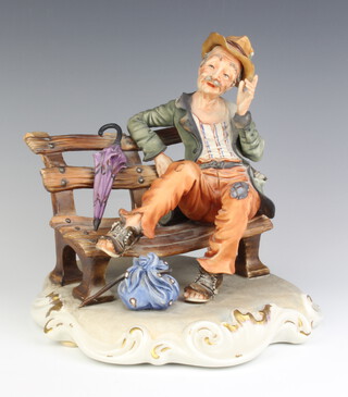 A Capodimonte figure of a tramp sitting on a bench by N Loky 25cm 