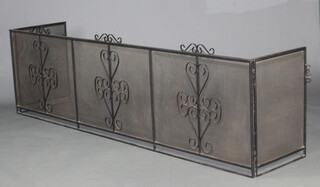 A Blacksmiths made wrought iron spark guard of large proportions 73cm h x 249cm w x 52cm d 
