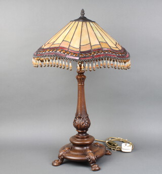 A Tiffany style bronzed table lamp with stained glass shade, raised on 4 hoof supports  73cm h x 42cm
