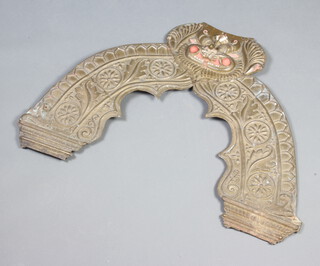 An "Indian" embossed metal door arch ornament, the top decorated a mask 60cm h x 51cm w 