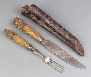 An 18th Century Dutch travelling eating set with steel blade and 4 pronged fork with hardwood handles carved figures, contained in an embossed leather scabbard marked YCDD Kendullzc Lvn8 ReGd 2Doorze 1770, 28cm overall  