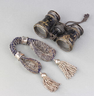 A pair of opera glasses together with a lady's purse 
