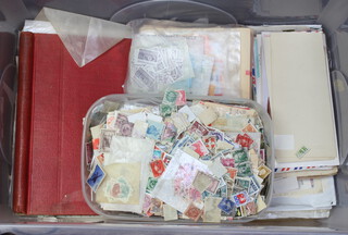 A large collection of world loose leaf pages of stamps, loose stamps, stamped envelopes etc (contained in a plastic crate)