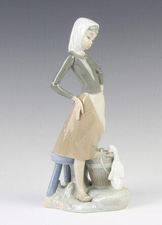 A Lladro figure of a girl with a bucket of water and a goose at her feet, 23 cm 