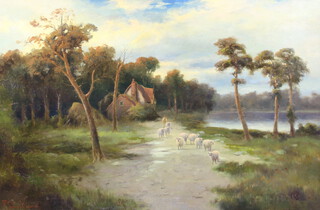 Elma Keene, 1853-1929, oil on canvas signed, a shepherd and flock beside a lake with distant thatched buildings, 49cm x 74cm 