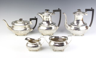 A Victorian 5 piece silver tea and coffee service with demi fluted decoration, raised on bun feet, having ebony mounts, Birmingham 1886 and 1895, gross weight 2586 grams 
