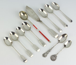 A Victorian silver butter knife (rubbed hallmarks) and minor silver spoons 245 grams