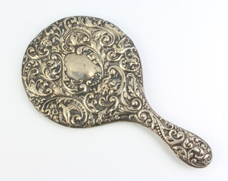 An Edwardian repousse silver hand mirror decorated with mythical beast, birds and scrolls, Chester 1902 
