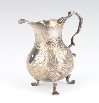 A Georgian repousse silver baluster cream jug with vacant cartouche on scroll feet, rubbed marks, 9.5cm, 90 grams