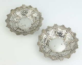A pair of Victorian pierced and repousse silver circular bon bon dishes, London 1894, 101 grams